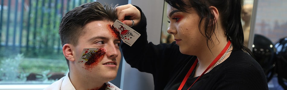 cards coming out of someone's face make up